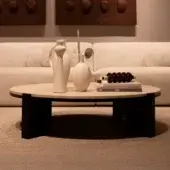Elegant Verzelloni Tivoli coffee table with Travertino marble top and black lacquered open-pore oak wood base exhibiting a polished sheen