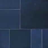 Cobalt blue rectangular tiles with semi-gloss finish arranged in a grid pattern, featuring visible grout lines and subtle tonal variations.