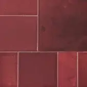 Red rectangular tiles in staggered brick layout with semi-gloss finish, gray grout, and mottled tonal variations for textured surface.