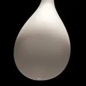 Frosted table lamp, translucent plastic, teardrop shape with rounded form, narrow neck, and bulbous base, emitting a soft, diffused glow.