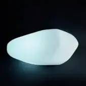 Wall light, white polyethylene, organic asymmetrical shape emitting diffused blue-white light against a dark gray backdrop.