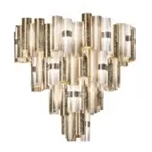 Gold tiered chandelier with cascading cylindrical elements, featuring textured metallic finish and subtle bronze accents, studio lighting.