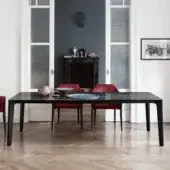 Superior Bontempi Versus table crafted with a sinuous steel frame and glossy black tabletop with grey veining