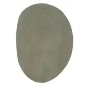 Olive-green rug, “ciclopi pietra palude”, asymmetrical shape with a dense pile and matte finish against a white backdrop.