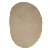 Irregularly shaped rug, sandy beige wool, smoothed stone form, plush pile texture, studio shot, neutral tone, diffused lighting.