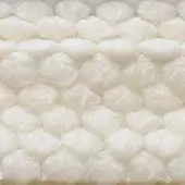 Clear plastic textile sample with repeating hexagonal air pockets, creating a cushioned cellular texture and subtle sheen, labeled “egoitaliano puffo 101”.