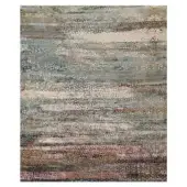 Rugiano Flora rug, rectangular, layered abstract pattern in gray, beige, blue, and pink tones with a dense, textured, granular appearance.