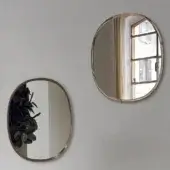 Elegant Bontempi Renoir mirror with curved oval silhouette and satin-finished muted gold-toned metal frame