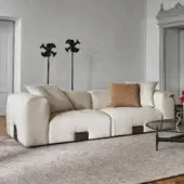 Distinguished Porada Koji sofa upholstered in light beige textured fabric with Canaletta walnut detailing presents a soft rounded form