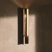 Sophisticated Visionnaire Polaris wall lamp with curved aluminum body and striated satin finish emitting a soft glow