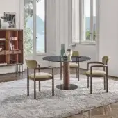 Elegant Porada Sansiro table with a clear glass top and a sculptural central leg crafted from canaletto walnut in Bronzoro finish