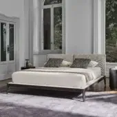 Refined Porada Ziggy Bed Soft with a solid canaletto walnut frame and fully upholstered light-colored headboard in matte finish