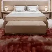 Refined Visionnaire Aubade bench with warm beige fabric upholstery and satin metal finishes on a solid wood frame