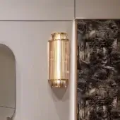 Distinguished Visionnaire Giano Wall Applique, a sculptural fixture crafted with satin steel and PVD gold borosilicate glass rods emitting ambient light