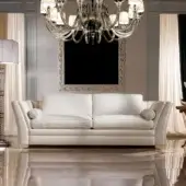 Elegant Zanaboni Amalfi sofa with a low profile and curved silhouette in off-white matte textile and luxurious goose down cushions