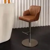 Superior Reflex Comfort stool in warm brown leather with brushed bronze metal base and curved silhouette