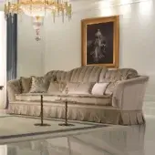 Exceptional Zanaboni Madison sofa with plush matte beige textile, traditional capitonné detailing and pleated skirt construction