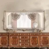 Distinguished Modenese Noble Etiquette mirror crafted in silver-toned gloss wood with intricate floral and foliate carvings