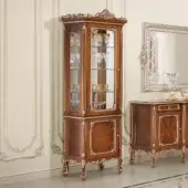 Distinguished Modenese Timeless Grace cupboard crafted with walnut finish and gold leaf detailing exhibiting a glass door and mirrored back