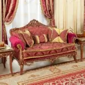 Distinguished Modenese Rubino Delight sofa upholstered in ruby-red damask with gold embroidery and a walnut finished hand-carved wooden frame