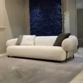 Distinguished Zanaboni Carol sofa with textured off-white textile upholstery and a dark accent band at the base