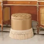 Sumptuous Modenese Royal Blend round ottoman crafted with golden-beige upholstery and delicate fringe detailing