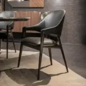Distinguished Zanaboni Egle armchair crafted with sculptural solid wood and premium leather upholstery in deep charcoal with a satin finish