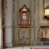 Distinguished Armando Rho A1427 clock crafted in California walnut burl with gilded accents and a noble marble top