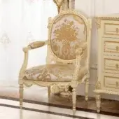 Lavish Modenese Golden Radiance lounge chair with ivory wood frame and gold-leaf embellishments upholstered in floral textile