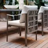 Superior Giorgetti Aldìa armchair with sleek metal frame and sculpted birch plywood details in light gray waterproof fabric