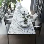 Superior Giorgetti Aldìa table with a substantial terrazzo tabletop and sleek metal frame built with a polished surface