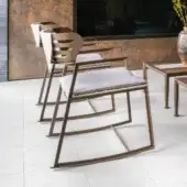 Exceptional Giorgetti Gea rocking lounge chair with a geometric stainless steel frame in carob finish and neutral beige birch cushions