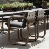 Distinguished Giorgetti Loop armchair with fluid lines and resilient Eva rubber cushions in darker grey waterproof textile crafted with grey water-polished ash wood and carob aluminum