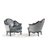 Distinguished Armando Rho A1384 lounge chair with light blue quilted upholstery and black distressed wood frame with antique silver leaf