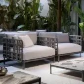 Elegant Giorgetti Aldìa lounge chair with pewter painted metal and natural reconstituted birch plywood backrest, upholstered in light grey-white fabrics