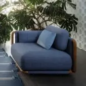 Elegant Giorgetti Moorea lounge chair with deep blue textile upholstery and warm painted teak inserts built with a pewter-painted stainless steel frame