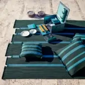 Distinguished Giorgetti Nisida rug crafted in Italy with bright turquoise and dark teal polypropylene braids and a coordinating fringed edge