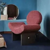 Distinctive Black Tie Onika lounge chair with muted rose textile upholstery and a dark-toned wood base accented with gilded details