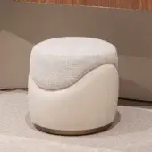 Distinguished Capital Clori ottoman with textured off-white fabric and smooth light beige material, accented by a refined metallic finish base