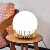 Superior Black Tie Lucy table lamp with glossy opal glass and satin-finish golden metal cage construction