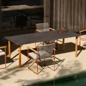 Architectural Atmosphera Pipe table with dark gres and solid Asian teak legs crafted with a satin finish