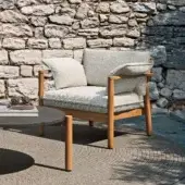 Distinctive Atmosphera Panama lounge chair with cylindrical teak frame and neutral beige textile upholstery in satin finish