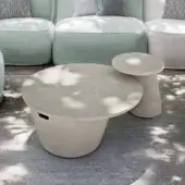 Distinguished Atmosphera Totem coffee table exhibiting a tactile concrete finish with a neutral gray tone and asymmetric cylindrical base