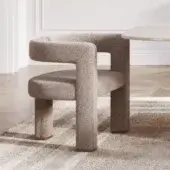 Distinguished Capital Mirage armchair with sculpted form upholstered in textured beige bouclé and subtle metal-finished details