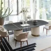 Distinctive Capital Rock table with shaped dark gray marble top and quilted creamy leather cylindrical bases