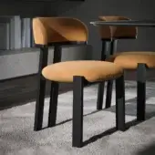 Distinguished Tonin Casa Camila chair with inviting golden-yellow textile upholstery and dark matte solid wood frame