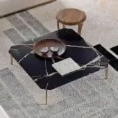 Captivating Capital Eclectic coffee table with black marble tabletop and sleek gold-toned metal legs