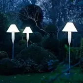 Elegant Serralunga Bonheur floor lamp with satin white shade and pale blue recyclable LLDPE, emitting ambient glow