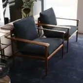 Elegant Giorgetti lounge chair with canaletto walnut frame satin finish and navy blue cushions padded with goose feathers