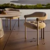 Elegant Greta Outdoor Armchair with beige-sand upholstered seat, tufted backrest, light gray matte metal legs
